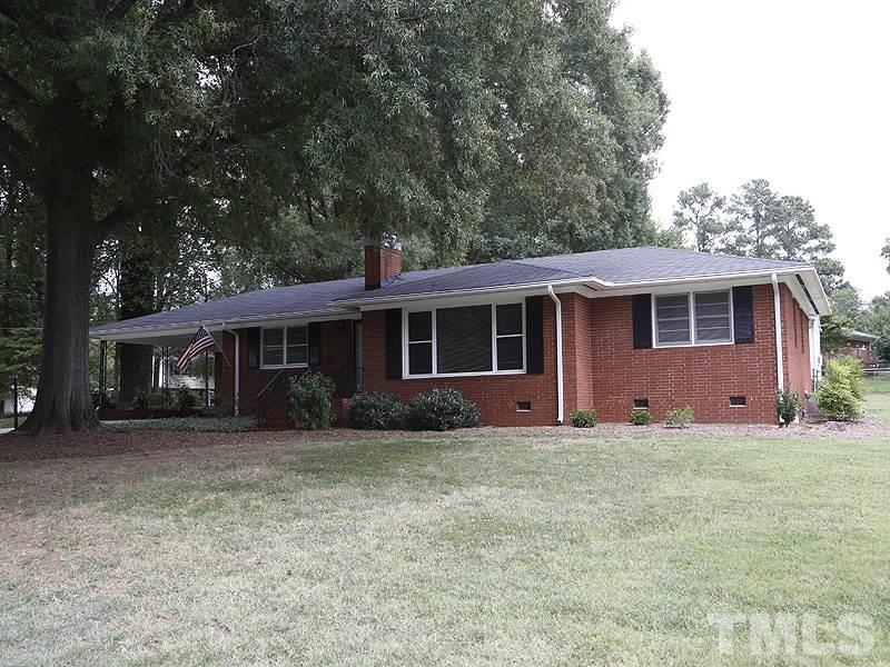 4801 Greenbrier Road Raleigh, NC 27603 - Photo 2 of 12 a front view of a house with a garden
