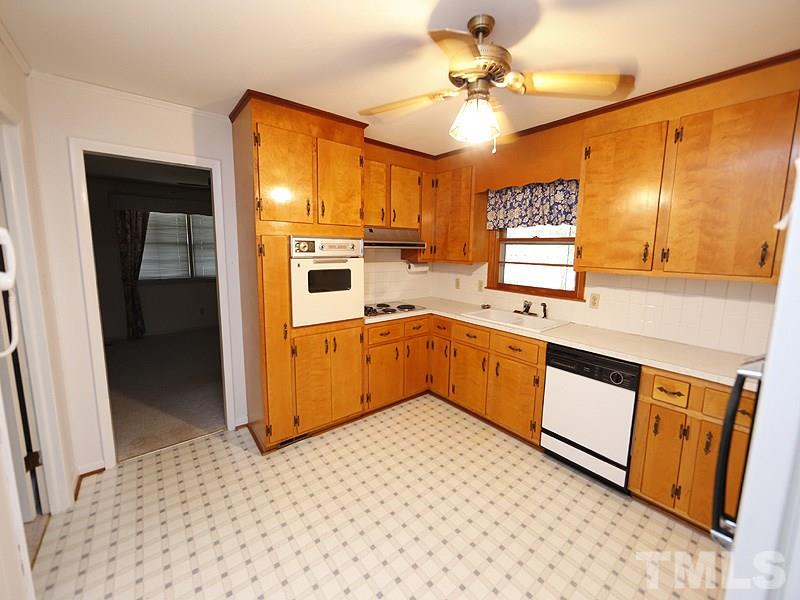 4801 Greenbrier Road Raleigh, NC 27603 - Photo 3 of 12 a kitchen with stainless steel appliances cabinets a sink and a stove