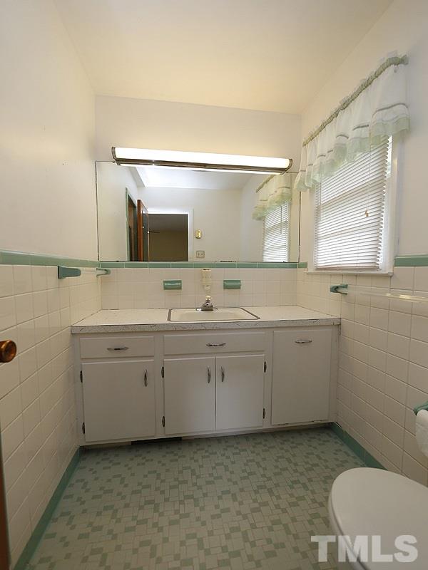 4801 Greenbrier Road Raleigh, NC 27603 - Photo 7 of 12 a spacious bathroom with a toilet sink and mirror