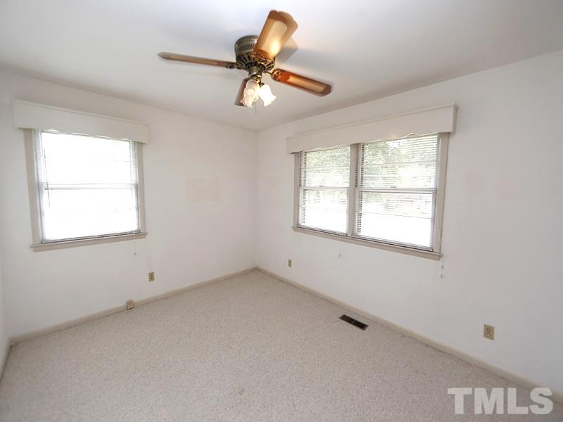 4801 Greenbrier Road Raleigh, NC 27603 - Photo 8 of 12 a view of room with a window and ceiling fan
