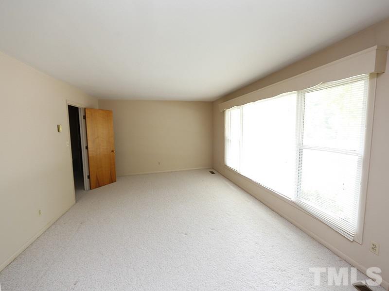 4801 Greenbrier Road Raleigh, NC 27603 - Photo 10 of 12 an empty room with a window
