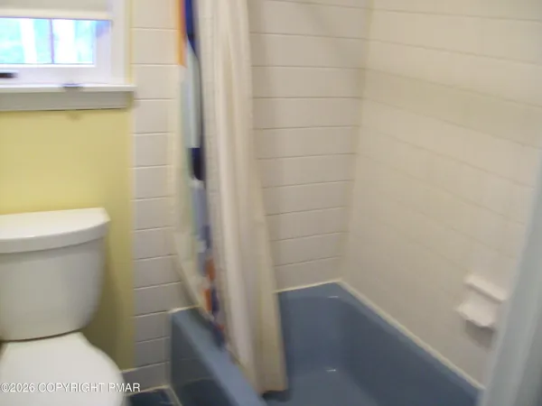 a bathroom with a sink and mirror with toilet