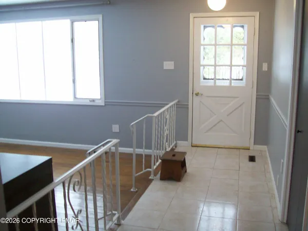 a view of an empty room with a fireplace and a window