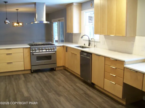 a metallic refrigerator freezer sitting in a kitchen