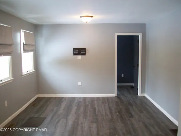 a room with wooden floor and a window