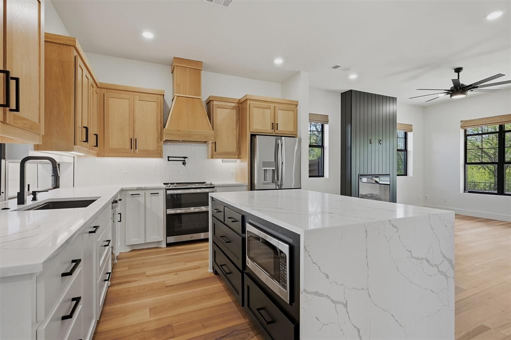 1805 Arthur Road Denison, TX 75021 - Photo 6 of 40 a kitchen with stainless steel appliances granite countertop a sink stove and refrigerator