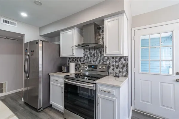 a kitchen with stainless steel appliances a stove and a refrigerator