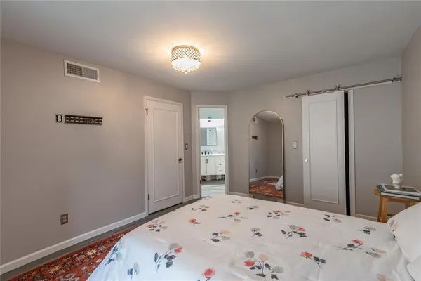 a bedroom with a bed and a mirror