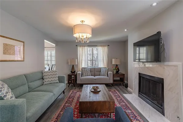 a living room with furniture a fireplace and a flat screen tv