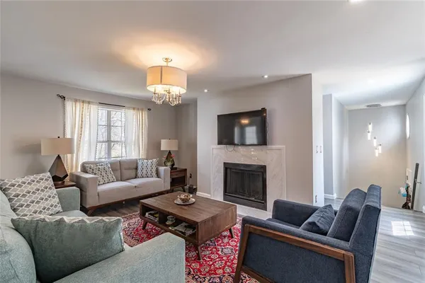a living room with furniture flat screen tv and a fireplace