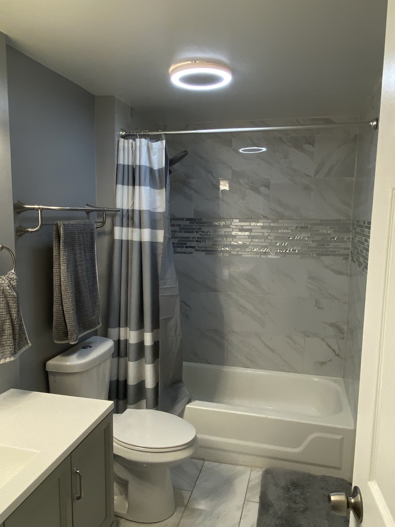 7000 Mather Avenue, Unit 101 Chicago Ridge, IL 60415 - Photo 12 of 21 a bathroom with a toilet and a shower