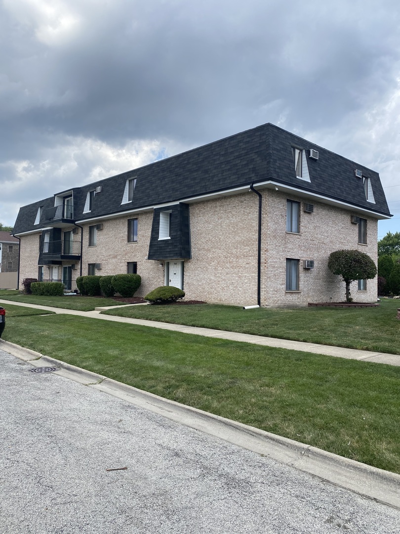 7000 Mather Avenue, Unit 101 Chicago Ridge, IL 60415 - Photo 3 of 21 a front view of a house with a yard and garage