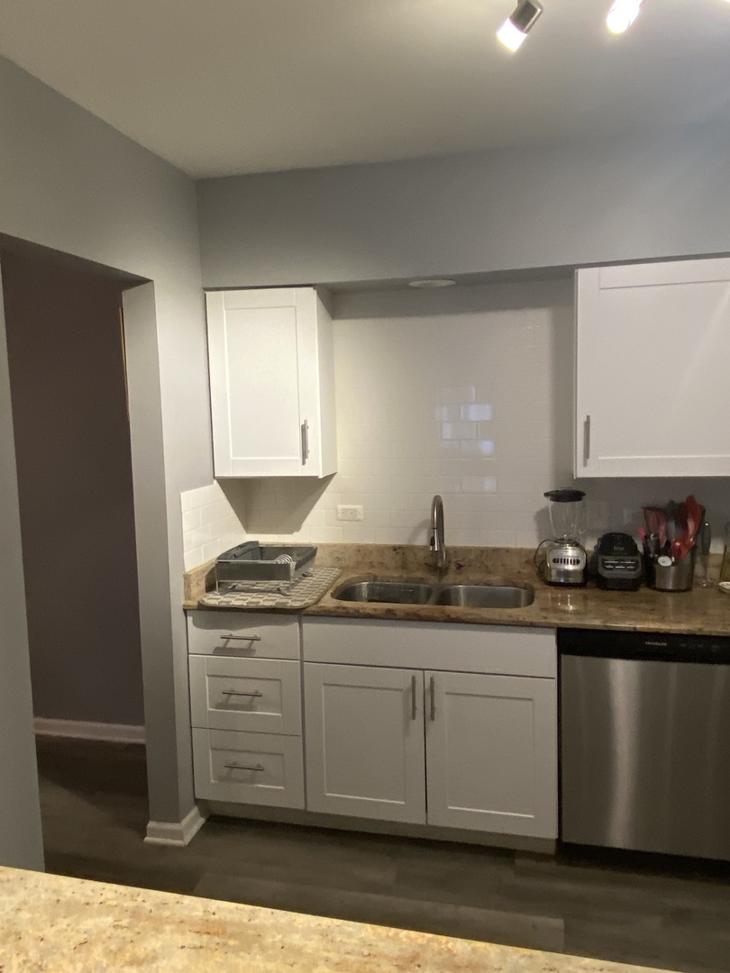 7000 Mather Avenue, Unit 101 Chicago Ridge, IL 60415 - Photo 7 of 21 a kitchen with stainless steel appliances granite countertop a sink and cabinets