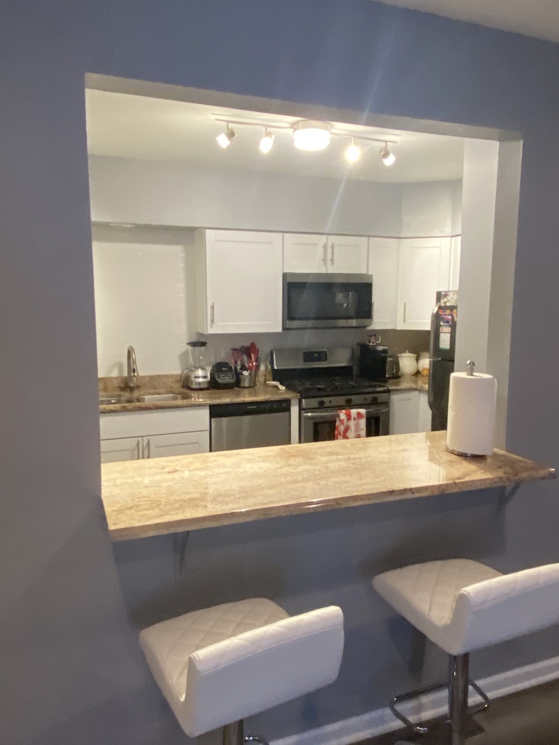7000 Mather Avenue, Unit 101 Chicago Ridge, IL 60415 - Photo 9 of 21 a kitchen with a table and chairs in it