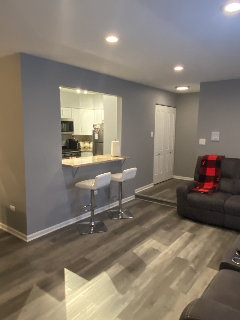 7000 Mather Avenue, Unit 101 Chicago Ridge, IL 60415 - Photo 10 of 21 a living room with furniture and a window