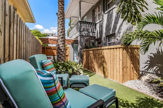 a view of a backyard with a patio and a garden