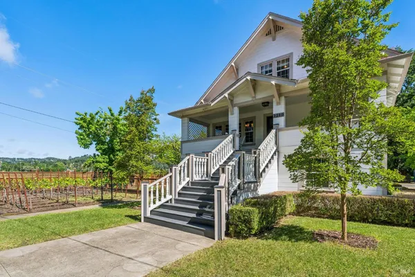 a front view of house with yard and green space