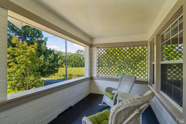 a view of a porch with furniture and garden