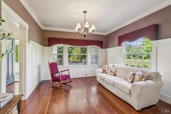a living room with furniture and a chandelier