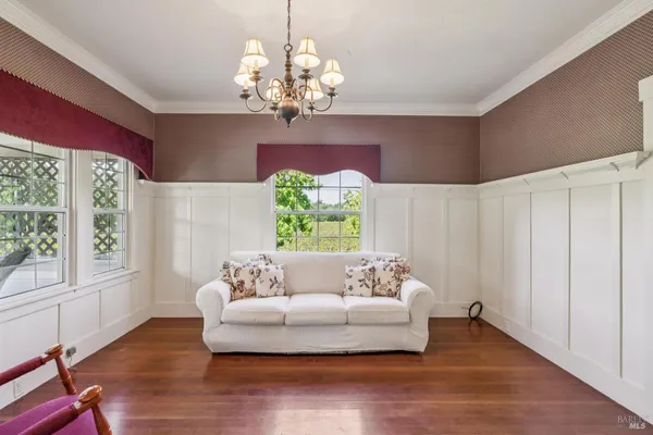 a living room with furniture and a chandelier
