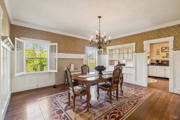 a view of a dining room with furniture window and wooden floor