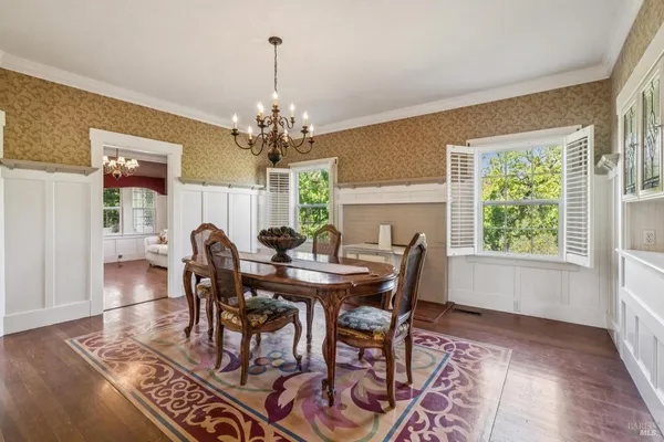a view of a dining room with furniture window and wooden floor