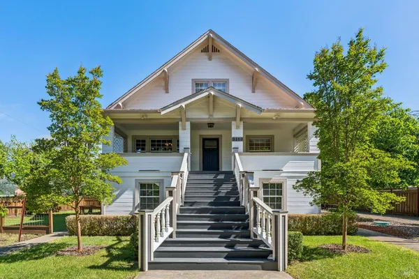 a front view of a house with a garden
