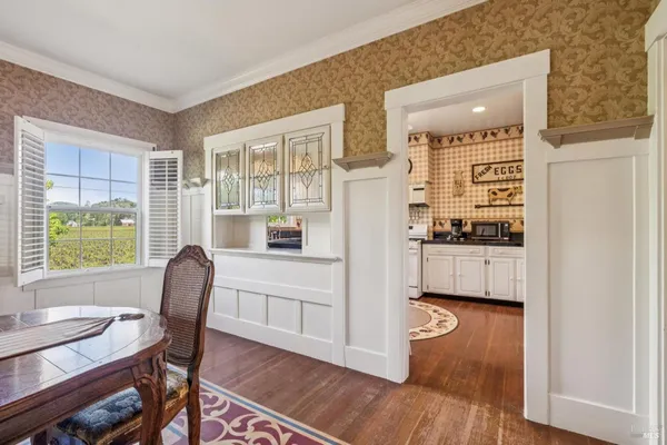 a kitchen with stainless steel appliances wooden floor and a refrigerator