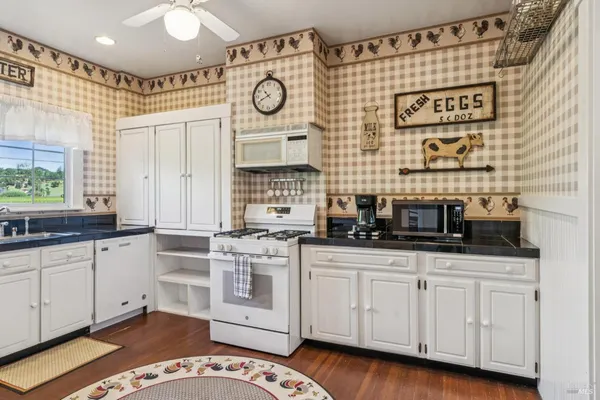 a kitchen with granite countertop a sink and cabinets