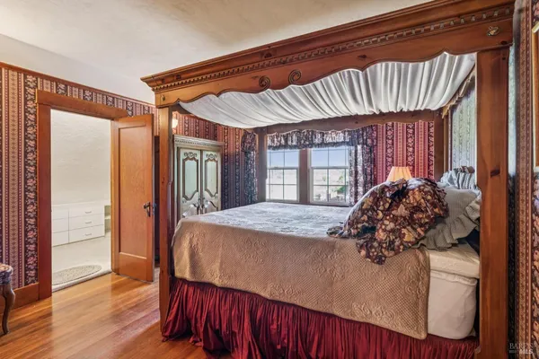 a bed sitting in a bedroom next to a window