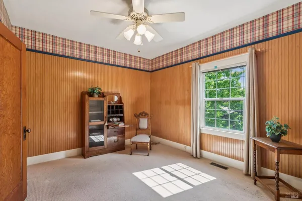 a bedroom with a bed chair and a window