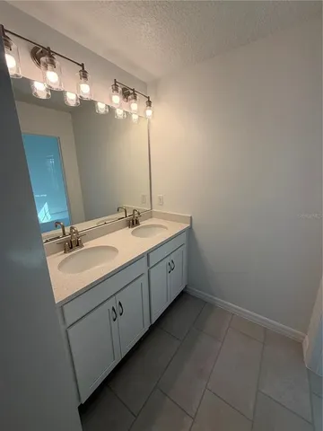 a bathroom with a glass door shower and a mirror