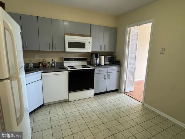 a kitchen with a refrigerator sink and cabinets
