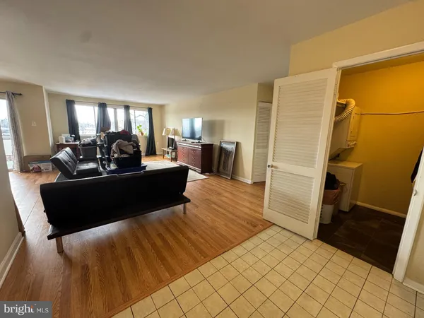 a living room with furniture rug and wooden floor