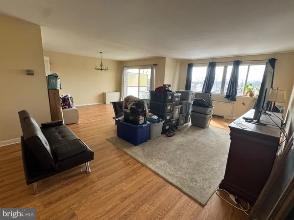 a living room with furniture a large window and a fireplace