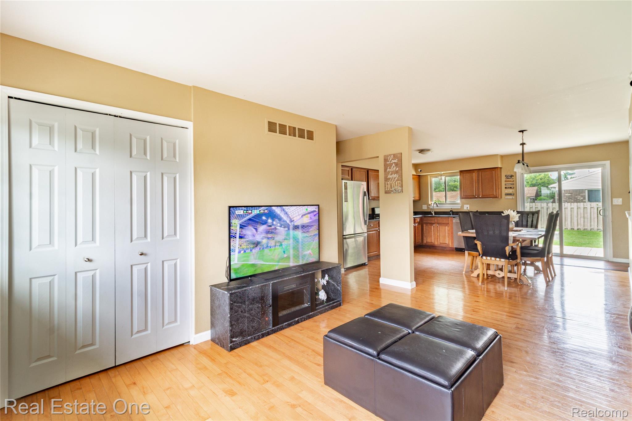 44220 Saltz Road Canton, MI 48187 - Photo 5 of 31 Open-concept living space featuring wood-finish flooring, a bi-fold door closet, and neutral wall tones