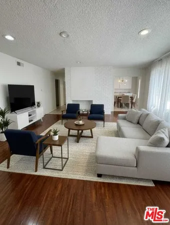 a bedroom with a bed and dresser with window