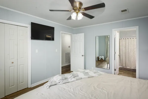 a bedroom with a bed and a chandelier