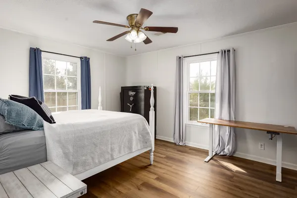 a bedroom with a bed and a window