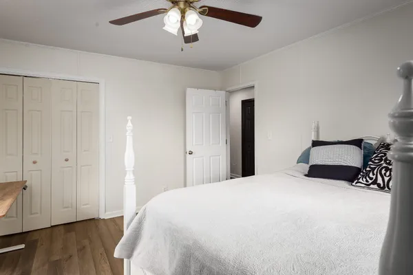 a bedroom with a large bed and a chandelier
