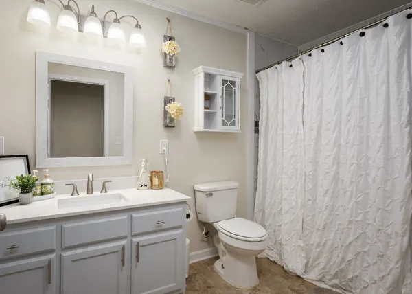 a bathroom with a toilet a sink and a mirror
