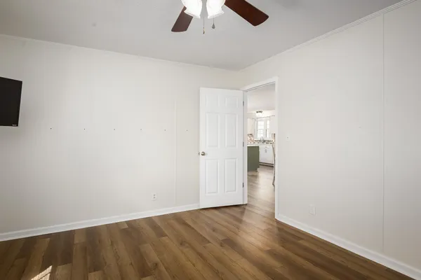 wooden floor in an empty room with a window