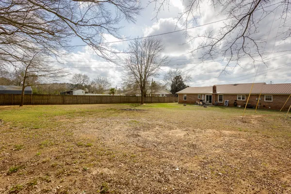 a view of swimming pool with outdoor seating and yard