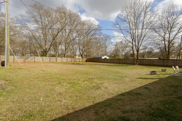 a view of yard with swimming pool and trees