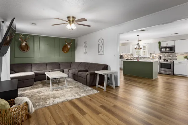 a living room with furniture and a wooden floor