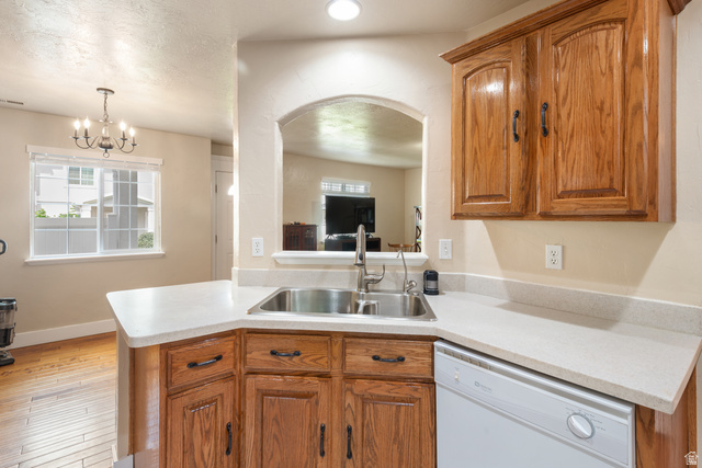 802 Brookside Court Payson, UT 84651 - Photo 17 of 32 Kitchen featuring wood finish cabinets, white dishwasher, light countertops, and hanging lights