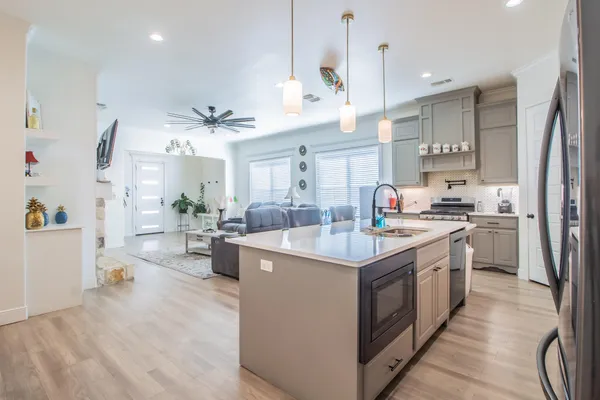 a kitchen with a sink stove and cabinets
