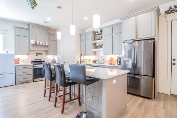 a kitchen with refrigerator cabinets and wooden floor