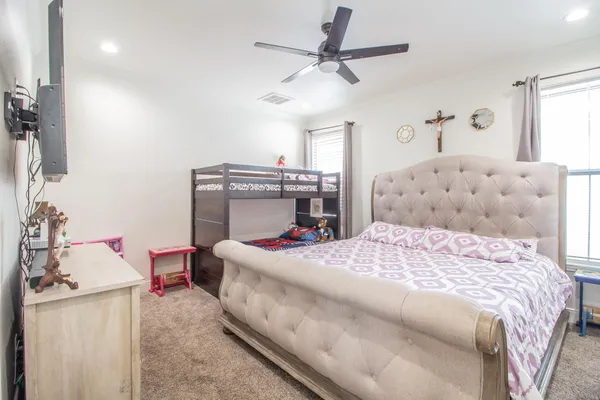 a bedroom with a bed and a chandelier