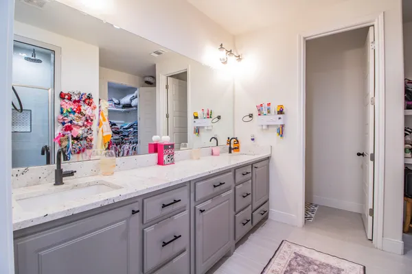 a bathroom with a double vanity sink mirror and double